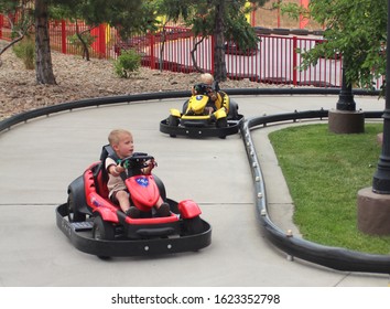 Denver Colorado USA - August 13, 2013.  Young Children Racing In Go Karts On A Figure Eight Track.  