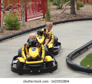 Denver Colorado USA - August 13, 2013.  Young Children Racing In Go Karts On A Figure Eight Track.  