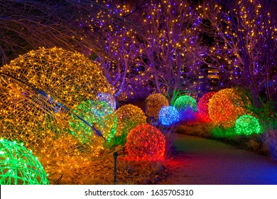 Denver, Colorado, USA - December 9, 2019: A Night View Of A Winding Path Lit By Colorful Lights At Denver Botanic Gardens During Its Holiday Blossoms Of Light Event. 