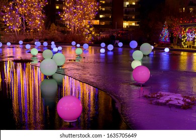 Denver, Colorado, USA - December 9, 2019: A Wide-angle Night View Of Colorful Lights Bright Up A Frozen Pond In Denver Botanic Gardens During Its Holiday Blossoms Of Light Event. 