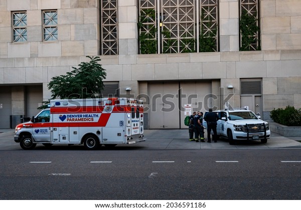 Denver,
Colorado, USA - July 27, 2021: Denver Health Paramedics arrive
outside the Van Cise-Simonet Detention Center in downtown Denver to
assist fire department and police on scene. 
