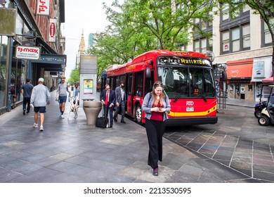 Denver, Colorado, USA, May, 2022, Electric, Battery Powered Public Transit Bus In Denver Downtown Shopping Walking Mall. Passengers And Pedestrians Walking On Sidewalks.