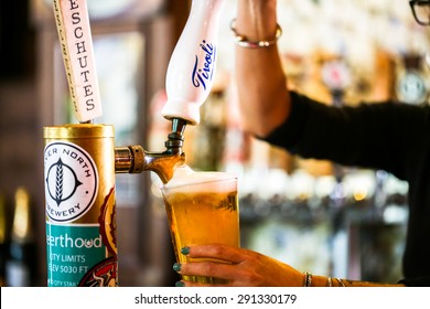 Denver, Colorado, USA-June 3, 2015. Bartender Pouring Draft Beer In The Bar.