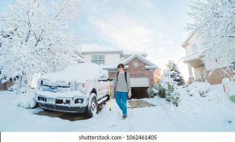 Denver, Colorado, USA-March 19, 2018-POV-Teenager Cleaning His Car From The Spring Snow Storm.