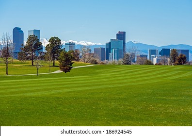 Denver Green Fields, Denver Downtown Skyline and Rocky Mountains Under the Snow. Colorado, United States.