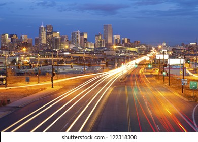 Denver. Image Of Denver And Busy Street With Traffic Leading To The City.