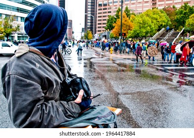 Denver - October 8th, 2011 - A photojournalist watches OccupyDenver protestors during a march in the rain.