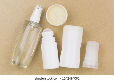 Deodorant Spray, roll-on, homemade cream, powder, mineral alum crystal stick. Underarm antiperspirant products with no aluminum salt on yellow tile background