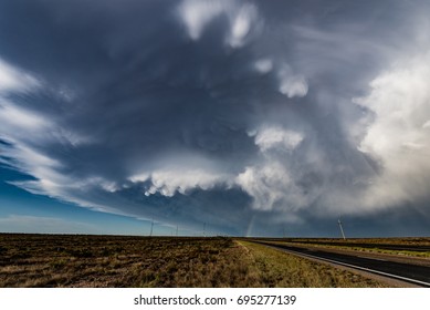 Departing supercell storm with impressive mammatus and a rainbow near Roswell, New Mexico, US.