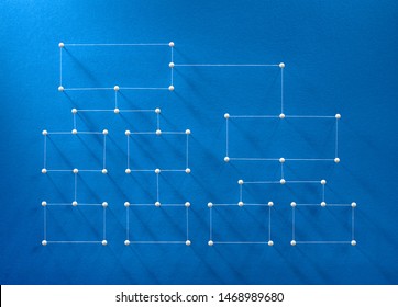 Department Hierarchy Concept. Network Of Pins And Threads In The Shape Of A Chart Symbolising Business Organisation Structure And Comunication Between Departments.