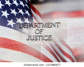 Department of Justice building sign with an American flag behind it