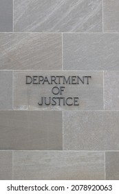 Department Of Justice Sign On Stone Wall In Washington DC, USA