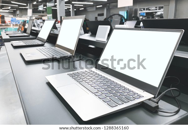 Department of laptops in the electronics store.\
Table showcase with laptops in the technology store. Choosing and\
buying a laptop in a technology\
store.