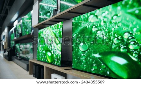 Department Store Electronics Section Showcasing a Range of of Modern Big TVs. Assorted Flat-Screen Televisions Convey Modernity and Technological Advancement with Perfect Quality and 4K Resolutions