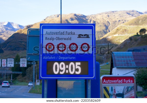 Departure\
board at car shuttle train terminal at mountain village Realp at\
Swiss mountain pass Furkapass on a sunny late summer morning. Photo\
taken September 12th, 2022, Realp,\
Switzerland.