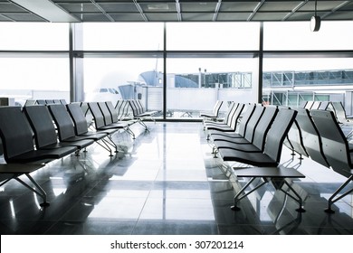 Departure lounge with chairs in airport - Shutterstock ID 307201214