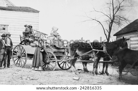 DEPARTURE FROM THE OLD HOMESTEAD, 1862 photograph by George Barnard shows a American family on the move during the Civil War. The pipe smoking woman may be a descendant of early Scotch-Irish settlers.