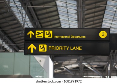 Departure And Priority Lane Information Board Sign With Yellow And White Character On Black Background At International Airport Terminal.