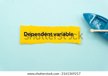 Dependent variable.The word is written on a slip of colored paper. Psychological terms, psychologic words, Spiritual terminology. psychiatric research. Mental Health Buzzwords.