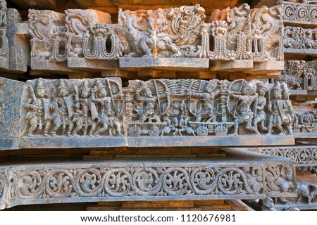 Depiction of Arjuna-Bhishma war from Mahabharata, at the base of temple, Hoysaleshwara temple, Halebidu, Karnataka, India.