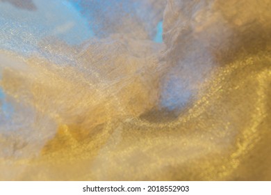 A Depiction of a Seascape, Showing a Blurred Fishing Net of Golden Bokeh Balls, Over a Tree Stump Background.