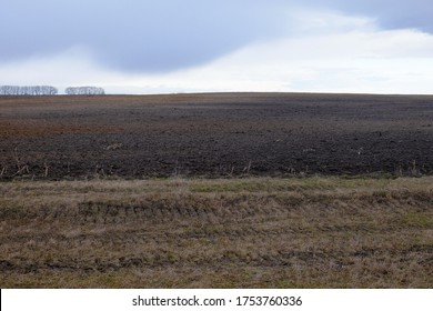 Depleted agricultural field on a cloudy evening. Moody landscape. - Shutterstock ID 1753760336