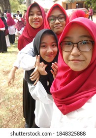 Depok, Indonesia-August 17th, 2020 : A Group Of Asian Teenager Girls Smiling And Do Self Portrait Happily. Hijab Teenager Girls Enjoy The Day. Indonesian Girls Gather In A Park. Hangout With Friends. 