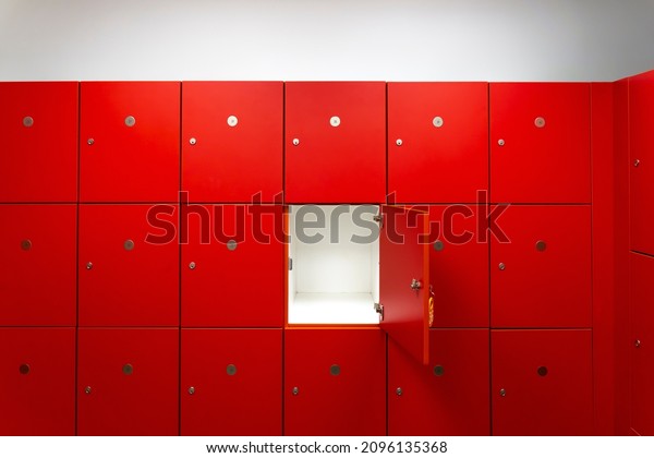Deposit red locker boxes or gym lockers\
inside of a room with one central opened\
door