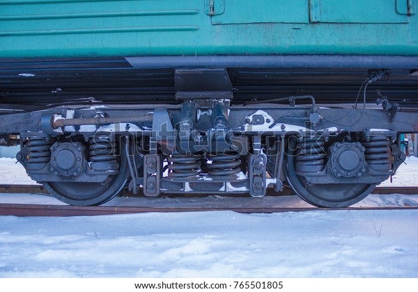 Depot, station, close-up of a train wheel on\
a steel rails. Around the snow, winter. Railway transportation,\
delivery of cargo and\
passengers.