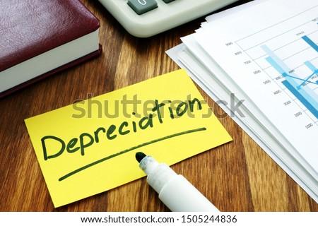 Depreciation concept. Stack of business papers.