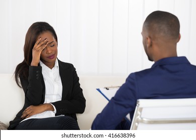 Depressed African American Woman At Psychiatrist Appointment