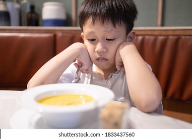 Depressed Asian Kid Boy With Anorexia,don't Have Appetite,child Kindergarten Bored With Food Or Boredom,refusing To Eat Vegetable Soup,unpalatable,tired Of Food,nutrition And Eating Disorder Concept