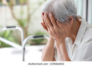 Depressed asian senior woman with depression,anxiety,depressive illness,tired old elderly patient crying alone at home,debilitating of disease,emotional problems,mood (affective)disorder,mental health - Shutterstock ID 2190464455