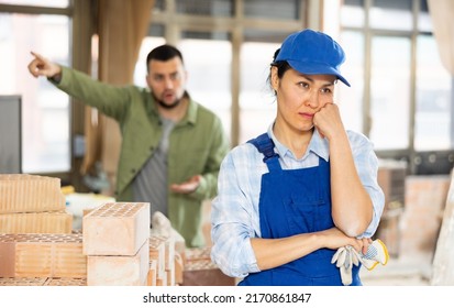 Depressed Asian Woman Builder Offended By Construction Manager Shouting In Background.