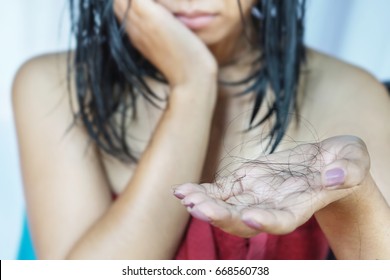 Depressed Asian Woman Holding Her Hair Loss While Taking A Shower