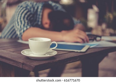 Depressed Businessman Leaning His Head Below when not success work. focus focus a cup of coffee. collapse concept, Vintage style.