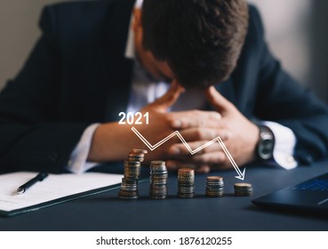 Depressed businessman lost his business due to the Covid-19 pandemic. Businessman destroyed in 2021. The concept of business loss, bankruptcy and crisis. - Shutterstock ID 1876120255