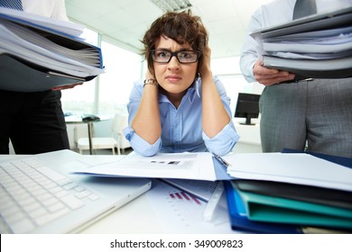 Depressed Businesswoman Has A Lot Of Work With Documents