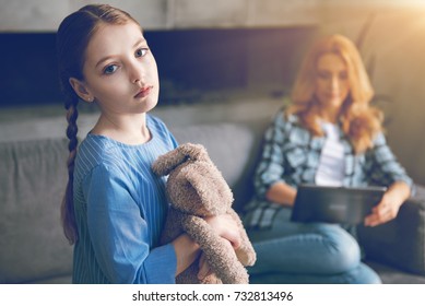 Depressed child waiting for mom to pay attention to her