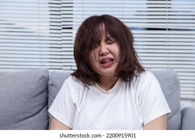 Depressed Chubby Woman Crying On A Sofa