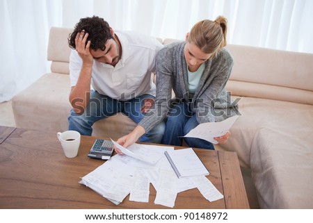 Depressed couple doing their accounting in their living room 商業照片 © 