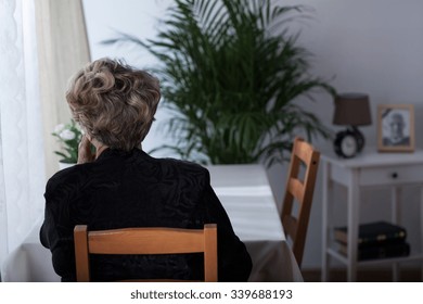 Depressed Elderly Widow Sitting Alone At Home