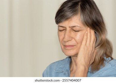 Depressed elderly woman having headache, touching temples. Stress, mental health, hormonal imbalance. Concept of women feeling unwell during menopause. Copy-space. - Powered by Shutterstock