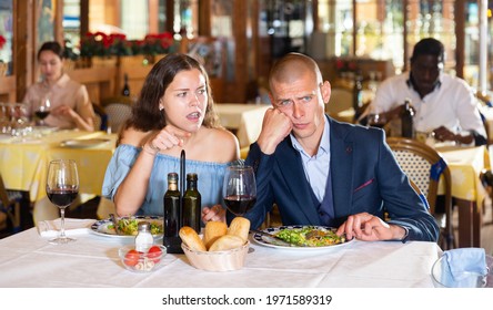 Depressed Family Couple Man And Woman Sitting At Restaurant Unhappy After Quarrel