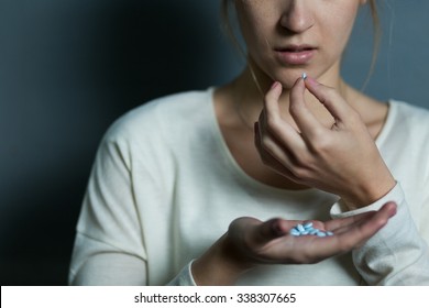 Depressed girl taking a lot of drugs