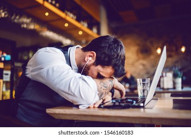 Depressed Handsome Caucasian Businessman Just Had Awkward Conversation Over Laptop. Cafe Interior.