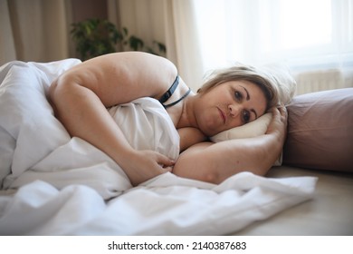 Depressed Lonely Fat Woman Lying In Bed At Home And Thinking.