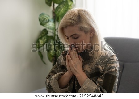 depressed lonely woman in military uniform at home