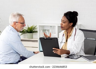 Depressed male senior adult in ambulance with afro american doctor. Doctor support and comforting her patient with sympathy - Powered by Shutterstock