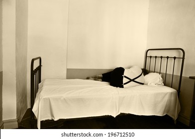 Depressed Man In Bed In A Mental Hospital.